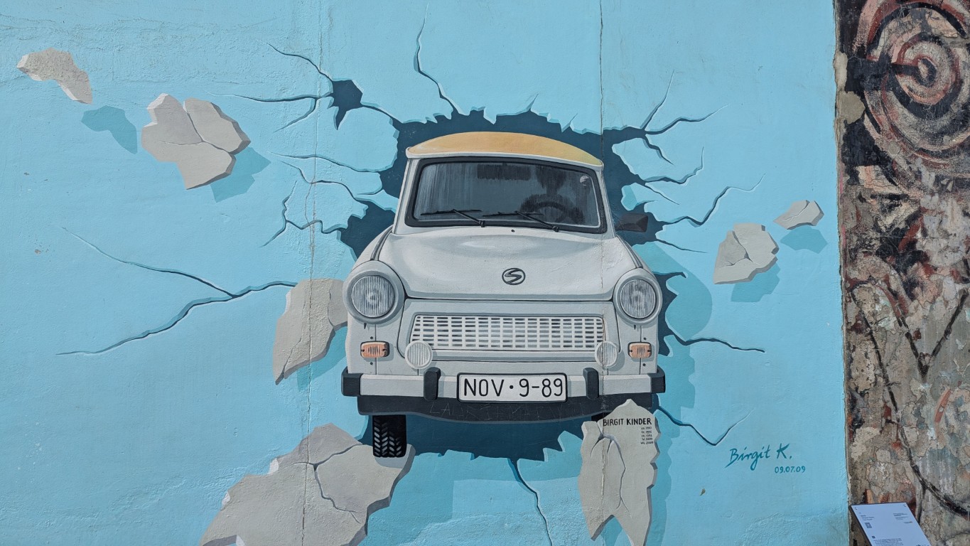 A Trabant car on a graffiti image at the East Side Gallery in Berlin